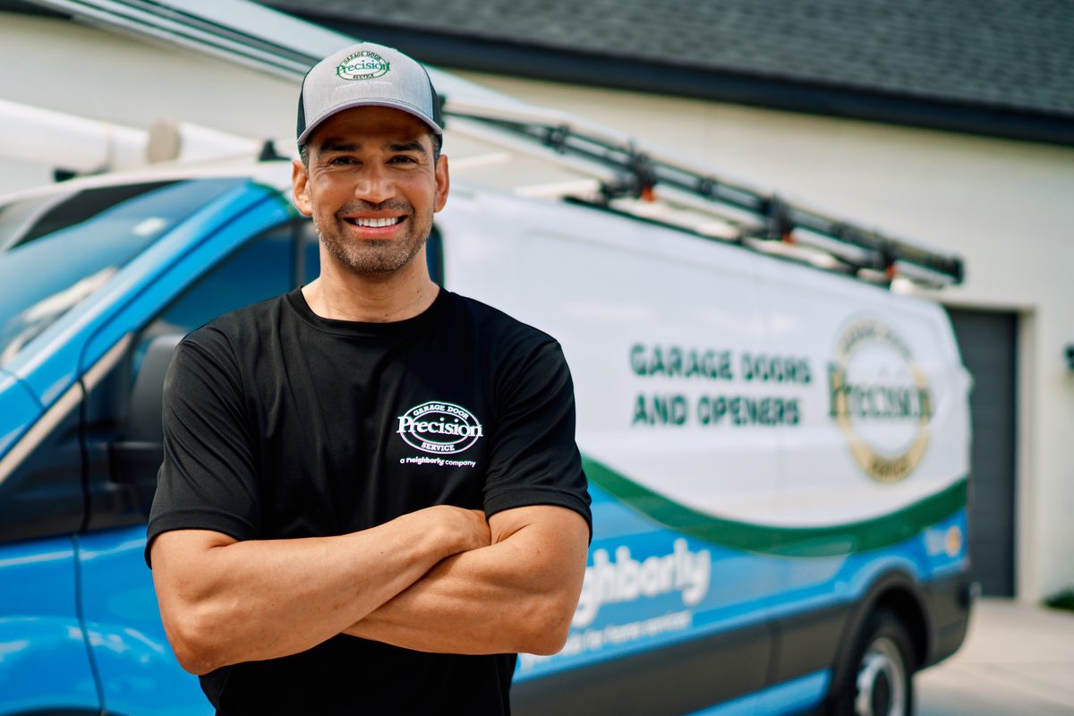 Precision Garage Door technician performing spring repair in Indianapolis, IN